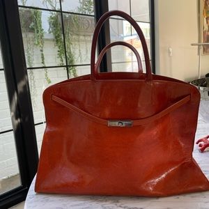 Furla handbag with silver claspand Inside zipper pocket.10x5x15in.handle5 1/2in.